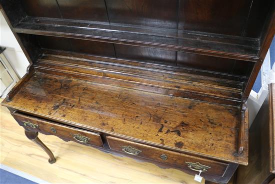 An 18th century oak dresser with boarded plate rack over W.137cm H.177cm